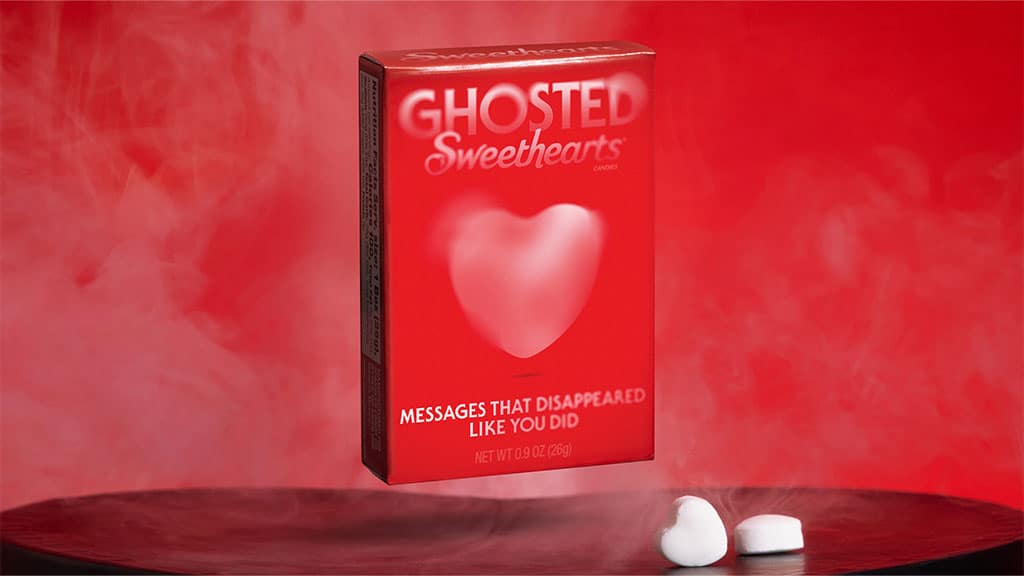 A red box of Ghosted Sweethearts featuring white heart candies with nothing written on them.
